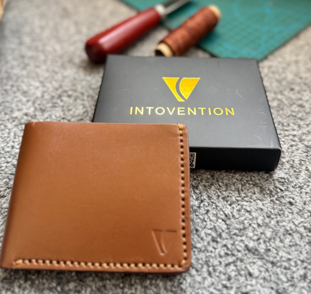 Cognac Intovention leather wallet with branded box and tools